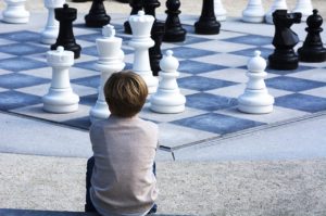 Boy planning chess